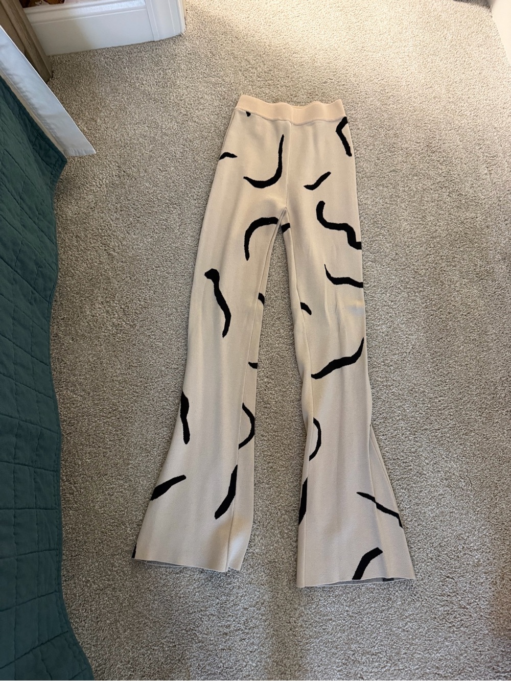 White Fox Boutique Beige Knit Flare Pants with Black Abstract Accents